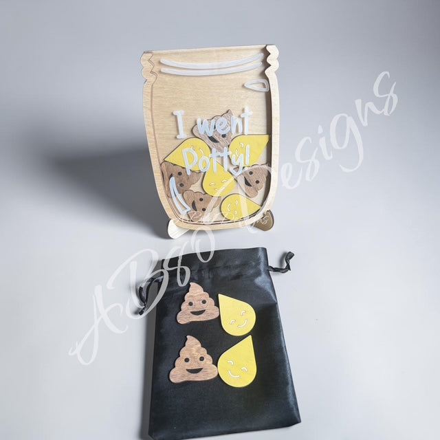 Mason jar-shaped product with 'I went potty!' text and poop emoji designs, displayed with a black drawstring bag on a gray background.